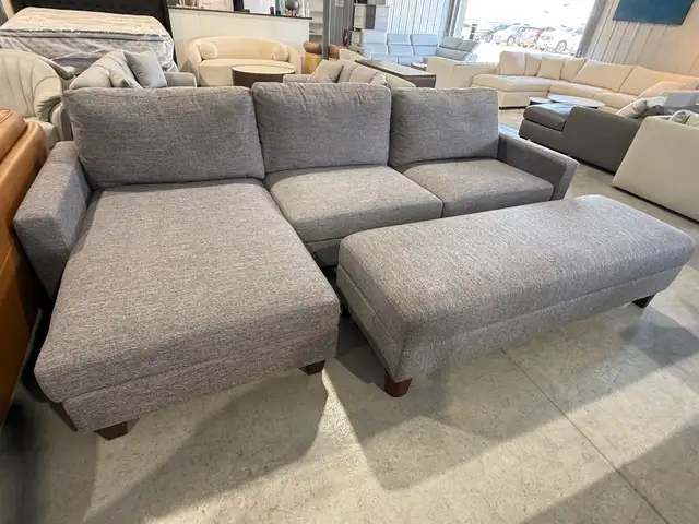 Grey fabric sectional with storage ottoman