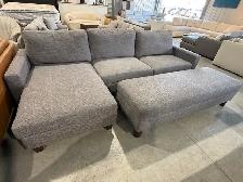 Grey fabric sectional with storage ottoman