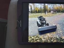 MUST SELL A TRACTOR WITH FRONT BRUSH ASKING $800.00 DOLLARS