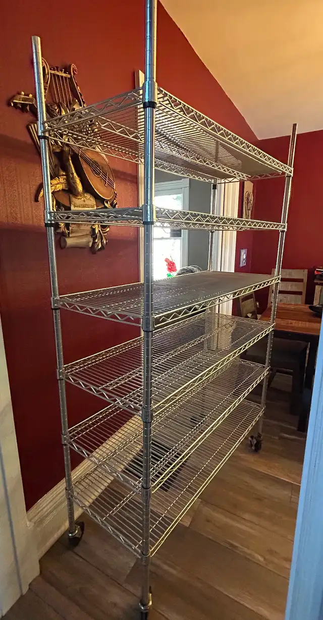 Six tier wire shelving unit on wheels