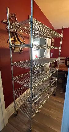 Six tier wire shelving unit on wheels
