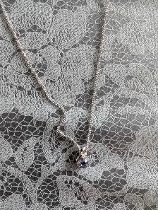 Silver-tone necklace with purple pendant