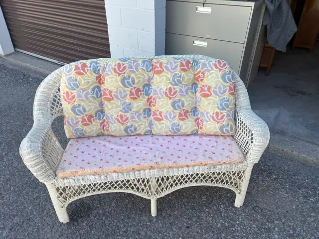 Free delivery used White Wicker Loveseat with Floral Cushions