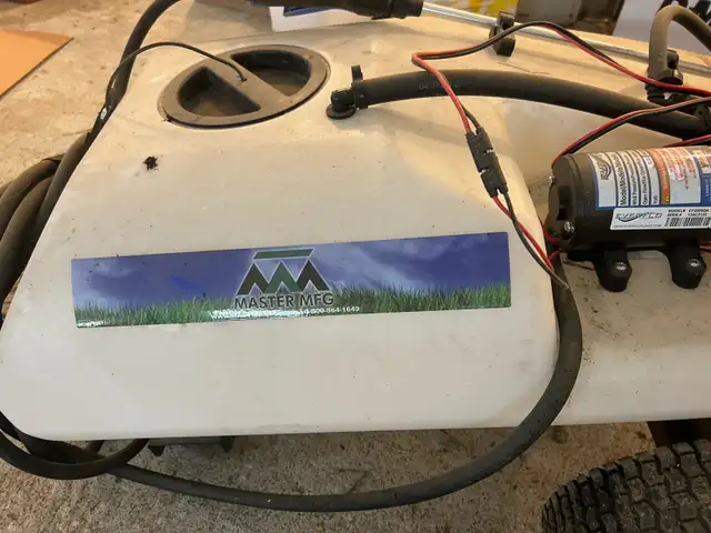 sprayer poles behind ATV or garden lawnmower