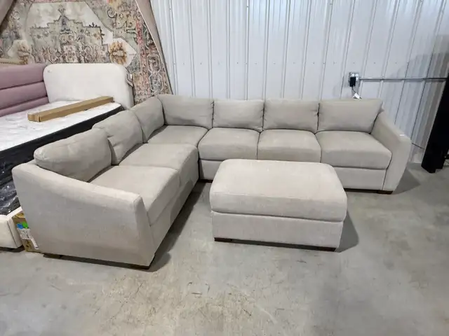 Beige fabric sectional with storage ottoman