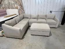 Beige fabric sectional with storage ottoman