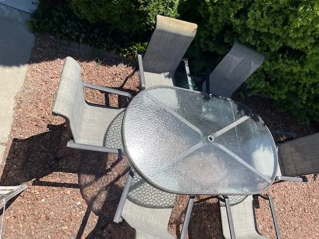 Aluminum outdoor dining table with six matching chairs