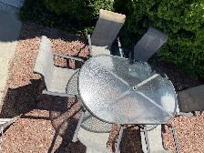 Aluminum outdoor dining table with six matching chairs