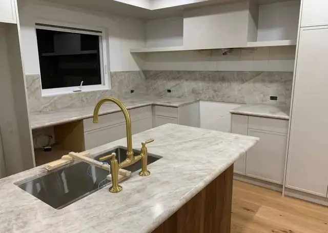 White Quartz Countertop With Golden Tap