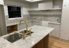 White Quartz Countertop With Golden Tap