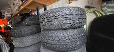Aftermarket black 'DAI' rims with studded tires - Photo 2