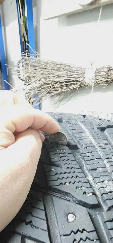 Aftermarket black 'DAI' rims with studded tires - Photo 5