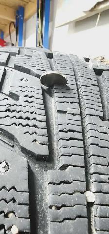 Aftermarket black 'DAI' rims with studded tires - Photo 6