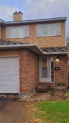 A fully furnished basement with a full bathroom and kitchen
