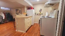 A fully furnished basement with a full bathroom and kitchen - Photo 4