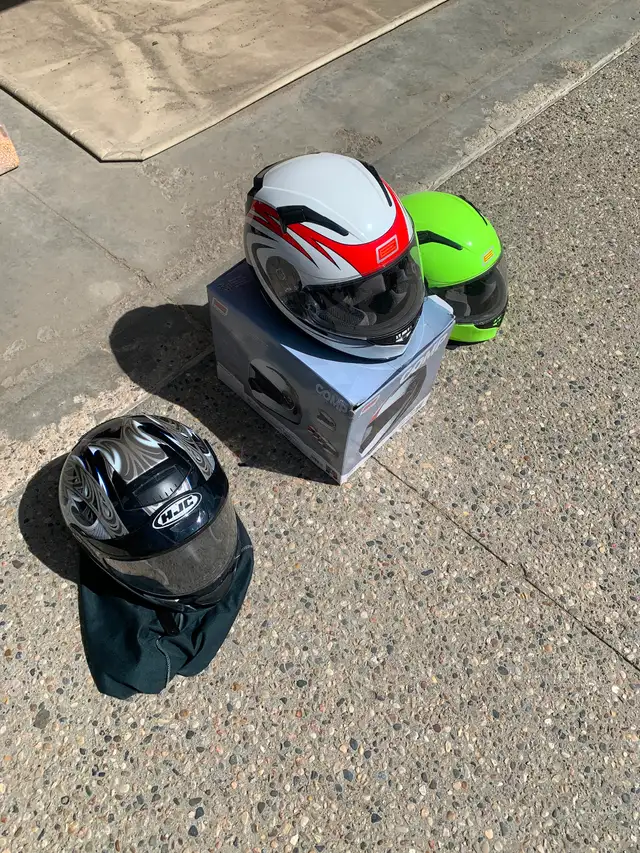 3 helmets,  1 adult,   2 kids
