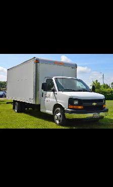 Moving truck with movers - Photo 3