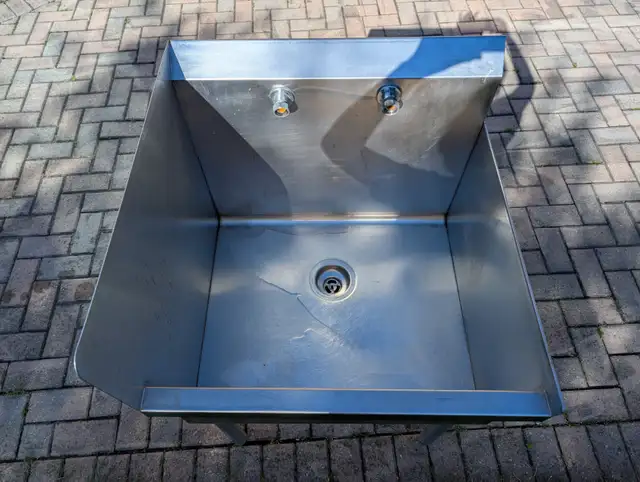 Commercial stainless steel utility sink with backsplash