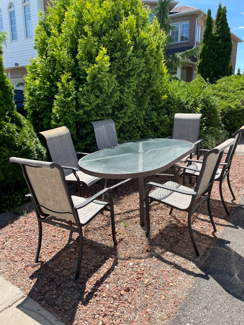 Aluminum outdoor dining table set with six matching chairs