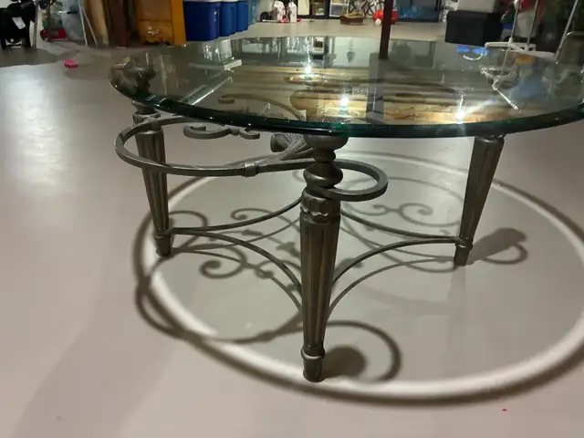 Elegant Round Glass Coffee Table with Ornate Metal Base – $200
