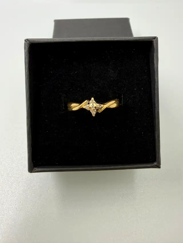 We are selling a10K Women's Ring With Small Diamond Chips~Size 6