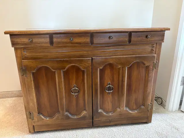 Singer sewing machine in cabinet with accessories