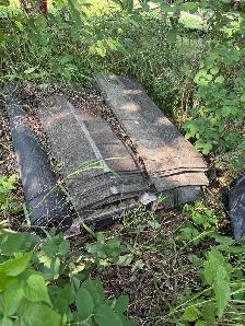 old shingles and black rolls of something