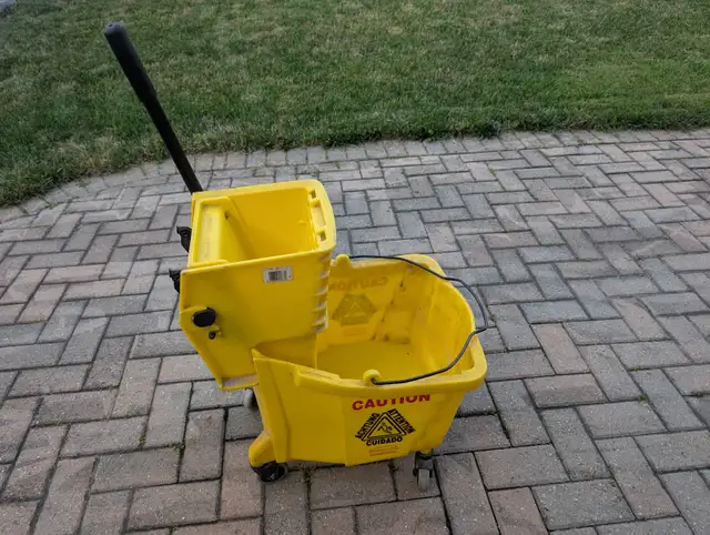 Heavy-duty commercial mop bucket with wringer.