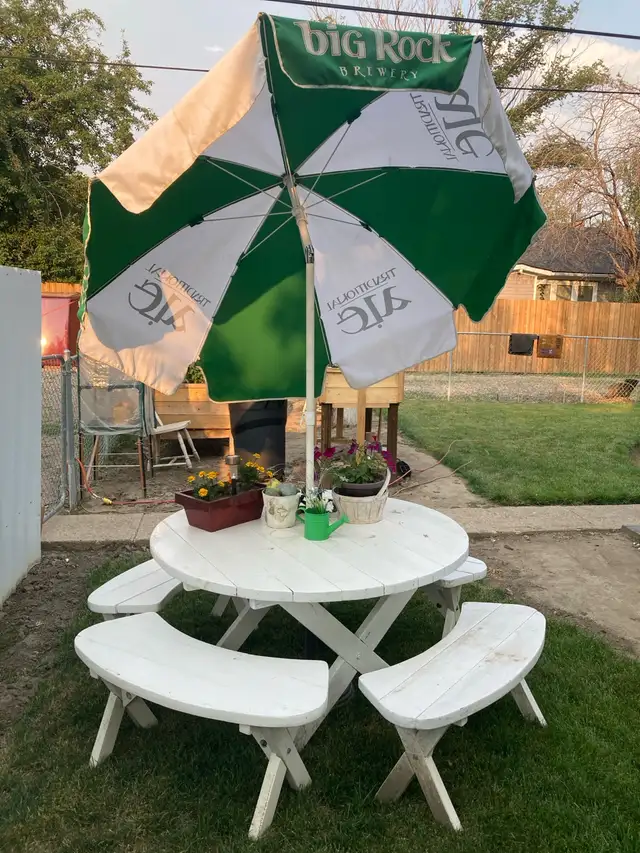 picnic table on wheels with umbrella.