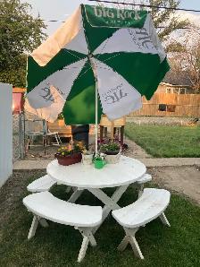 picnic table on wheels with umbrella.