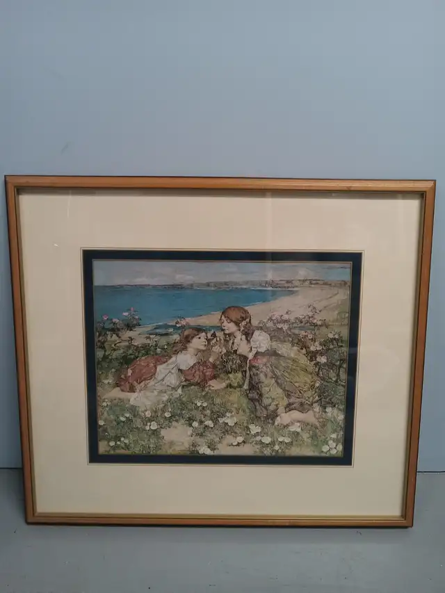 PICTURE OF 2 LADYS ON GRASS BY BEACH  IN BROWN FRAME