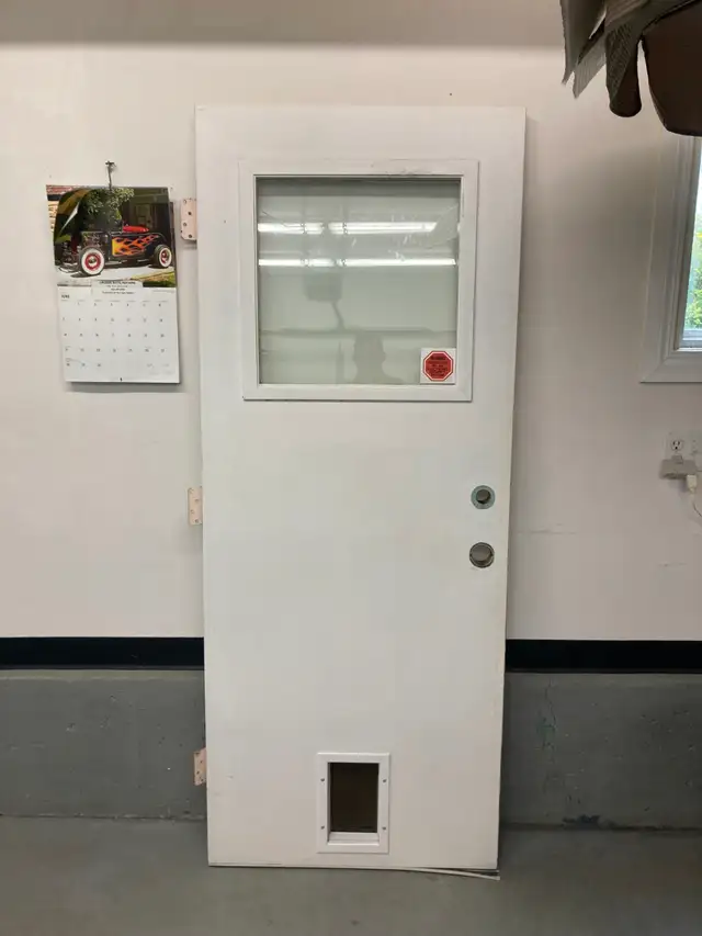 32x80 Steel Entry Door Comes with Installed Dog Door $40