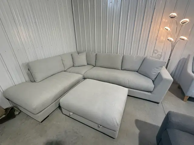 Large grey fabric sectional with ottoman
