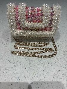 Pink purse white pearls and gold colored chain