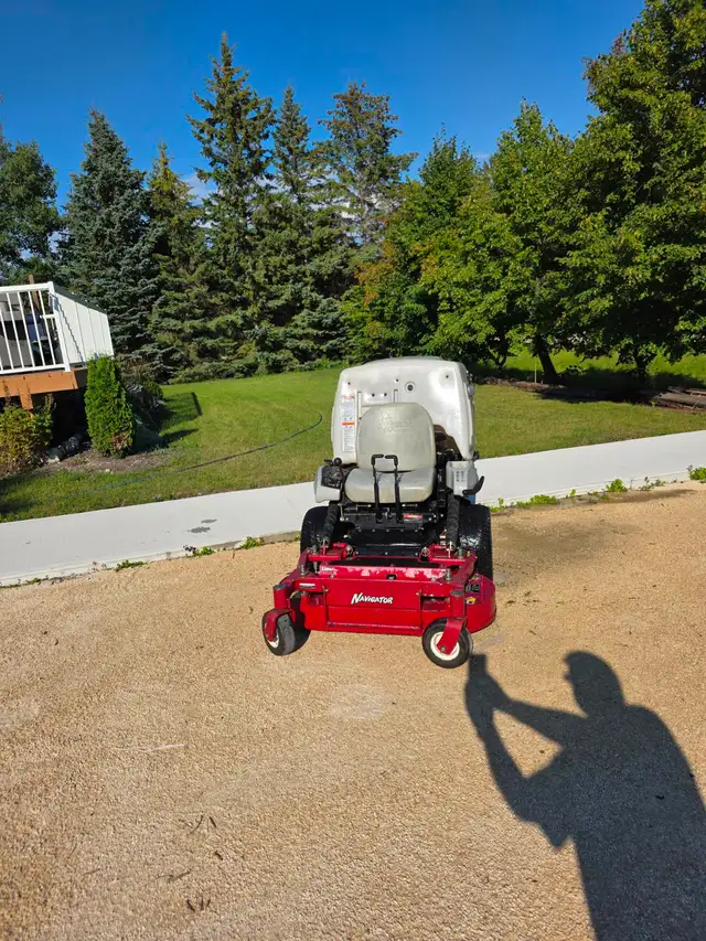 Exmark Navigator zero-turn mower in good working condition.