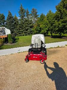 Exmark Navigator zero-turn mower in good working condition.