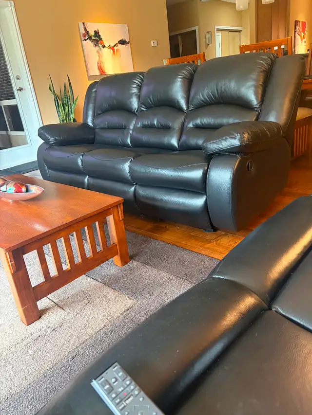 Brand new black recliner sofa .