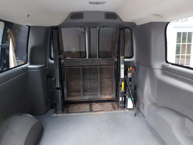 Wheel chair lift for a full size van