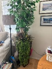 Tall artificial tree in a large container
