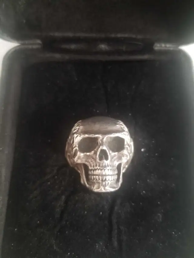 Travis Barker clocks and color sterling silver skull ring