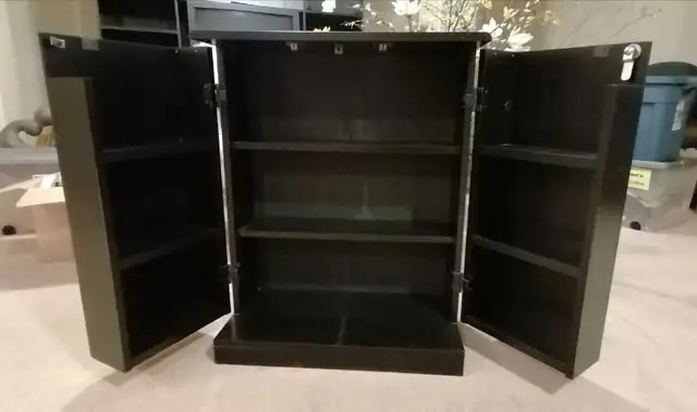 A black wooden storage cabinet featuring multiple open compartme