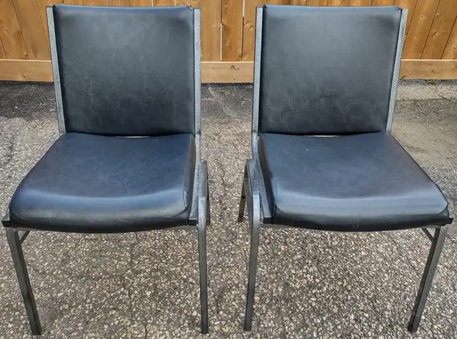 Two metal stackable chairs.