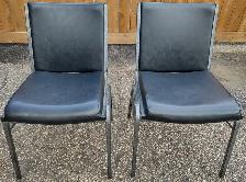 Two metal stackable chairs.