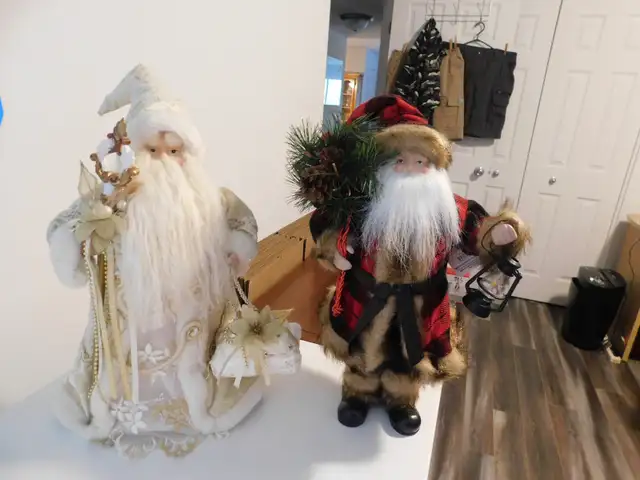 A pair of Santa Clause's in different Costumes.