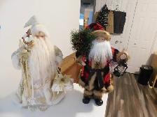 A pair of Santa Clause's in different Costumes.