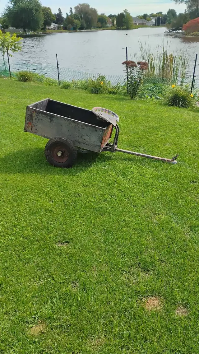 Antique metal dumping garden trailer