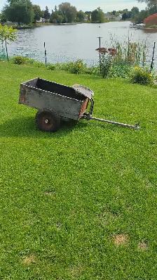 Antique metal dumping garden trailer