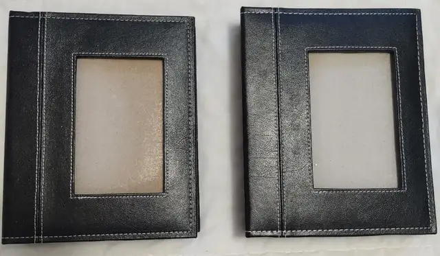 Two photo albums with black covers.