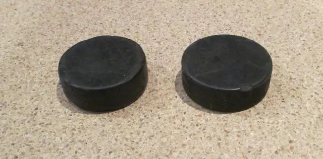 2 Used Regular Sized Hard Rubber Hockey Pucks