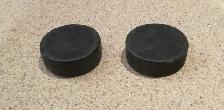 2 Used Regular Sized Hard Rubber Hockey Pucks